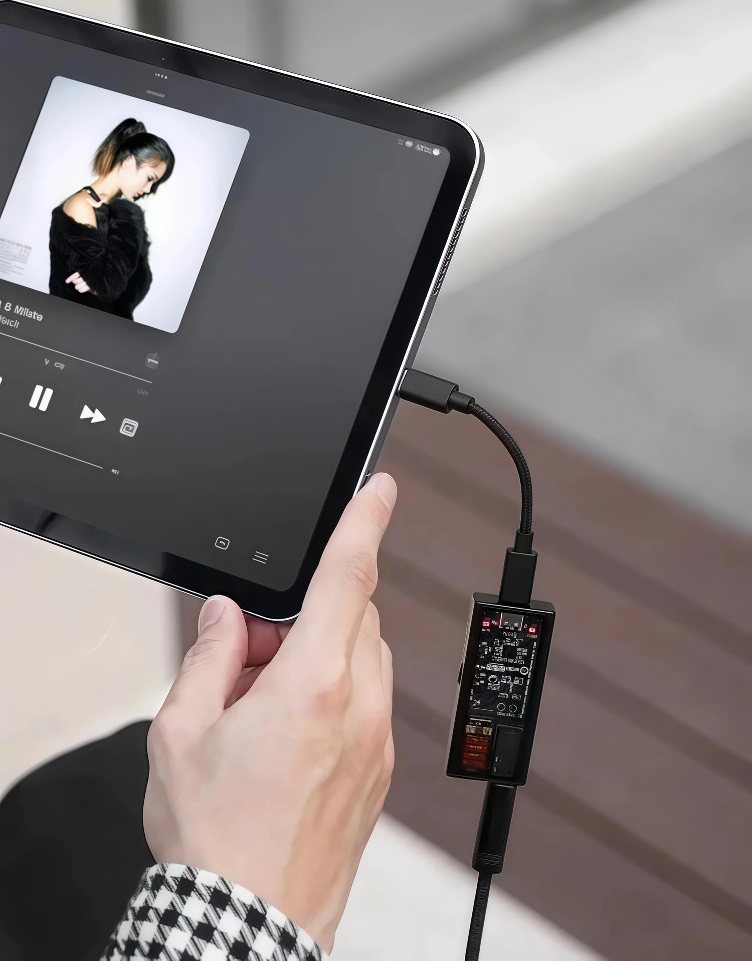 Questyle M15C portable DAC AMP connected to tablet playing music.